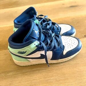 Blue, green, and white Jordan’s. Lightly used, size 5.5 US big kids.